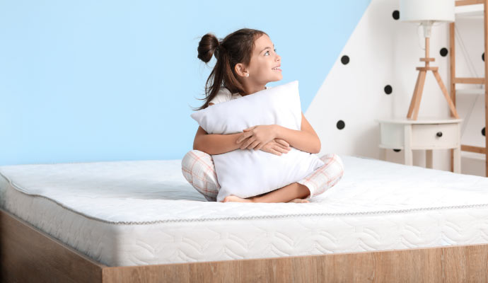 Children sitting on a mattress