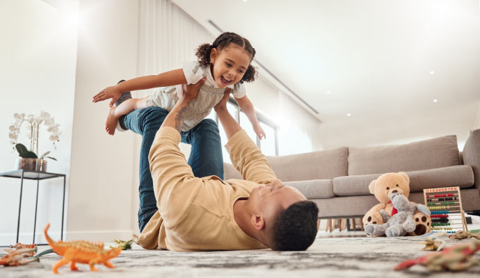 A father playing with his daughter in clean room
